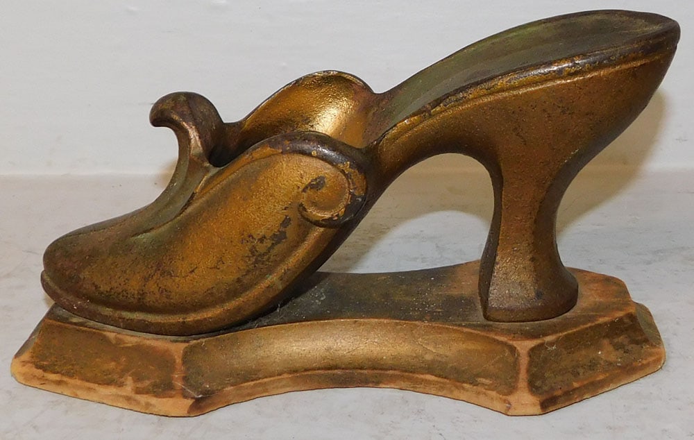 Antique Cast Iron High Heel Door Stop on Wood Base: Antique Cast Iron High Heel Door Stop on Wood Base. 5" H 9" W ALL DESCRIPTIONS AND ANY CONDITION STATEMENT GIVEN BY LANGSTON AUCTION GALLERY ARE STRICTLY OPINIONS AND LANGSTON'S SHALL HAVE NO
