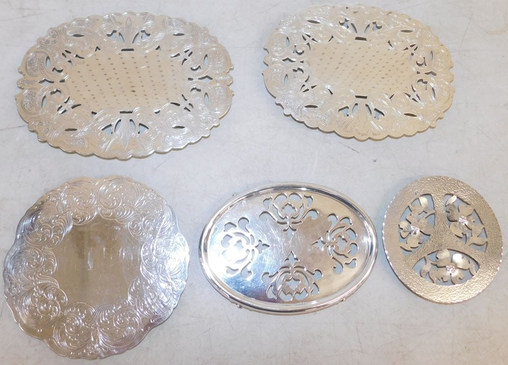Five Silverplated Trivets: Five Silverplated Trivets. Up to 8 1/2" x 6 1/2" ALL DESCRIPTIONS AND ANY CONDITION STATEMENT GIVEN BY LANGSTON AUCTION GALLERY ARE STRICTLY OPINIONS AND LANGSTON'S SHALL HAVE NO RESPONSIBILITY FOR ER