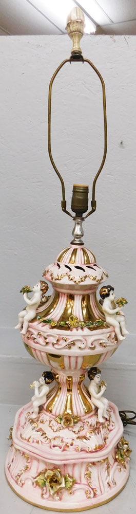 Porcelain Capodimonte Lamp with Cupid Motif: Porcelain Capodimonte Lamp with Cupid Motif . 37 1/2" H 10 1/2" Dia. ALL DESCRIPTIONS AND ANY CONDITION STATEMENT GIVEN BY LANGSTON AUCTION GALLERY ARE STRICTLY OPINIONS AND LANGSTON'S SHALL HAVE NO R