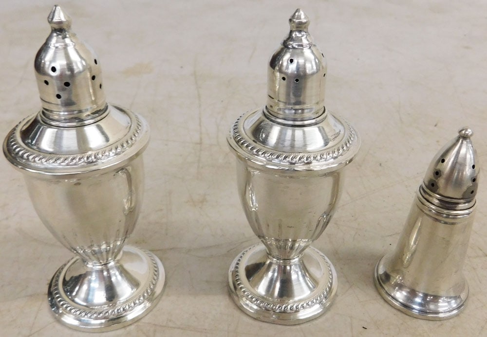 Three Sterling Weighted Salt & Pepper Shakers: Three Sterling Weighted Salt & Pepper Shakers . Up to 4 3/4" H 1 3/4" Dia. ALL DESCRIPTIONS AND ANY CONDITION STATEMENT GIVEN BY LANGSTON AUCTION GALLERY ARE STRICTLY OPINIONS AND LANGSTON'S SHALL HAV