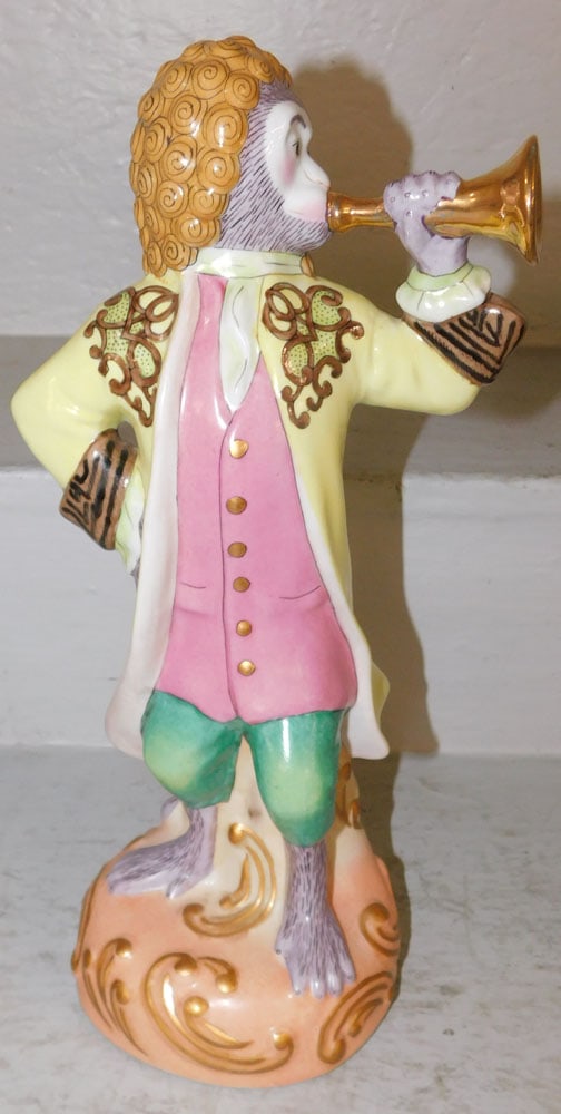 Painted Porcelain Musician Monkey Figure: Painted Porcelain Musician Monkey Figure. 13 1/2" H 7" W ALL DESCRIPTIONS AND ANY CONDITION STATEMENT GIVEN BY LANGSTON AUCTION GALLERY ARE STRICTLY OPINIONS AND LANGSTON'S SHALL HAVE NO