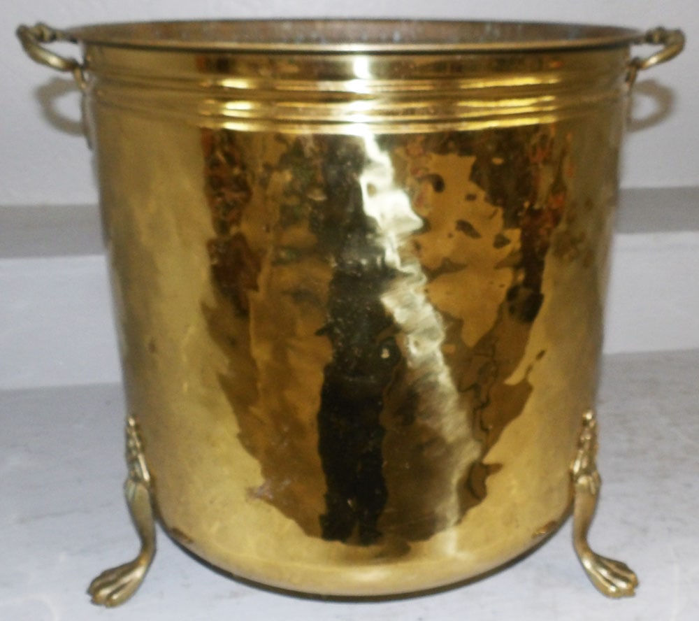 Two Handled Hammered Footed Brass Jardiniere: Two Handled Hammered Footed Brass Jardiniere. 15 1/2" H 17 1/2" W ALL DESCRIPTIONS AND ANY CONDITION STATEMENT GIVEN BY LANGSTON AUCTION GALLERY ARE STRICTLY OPINIONS AND LANGSTON'S SHALL HAVE NO