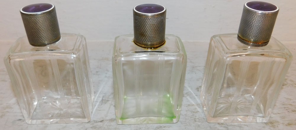 Three Sterling Top French Art Deco Perfume Bottles: Three Sterling Top French Art Deco Perfume Bottles. 4 1/2" H 2 1/2" W 1 1/2" D ALL DESCRIPTIONS AND ANY CONDITION STATEMENT GIVEN BY LANGSTON AUCTION GALLERY ARE STRICTLY OPINIONS AND LANGSTON'S SHALL