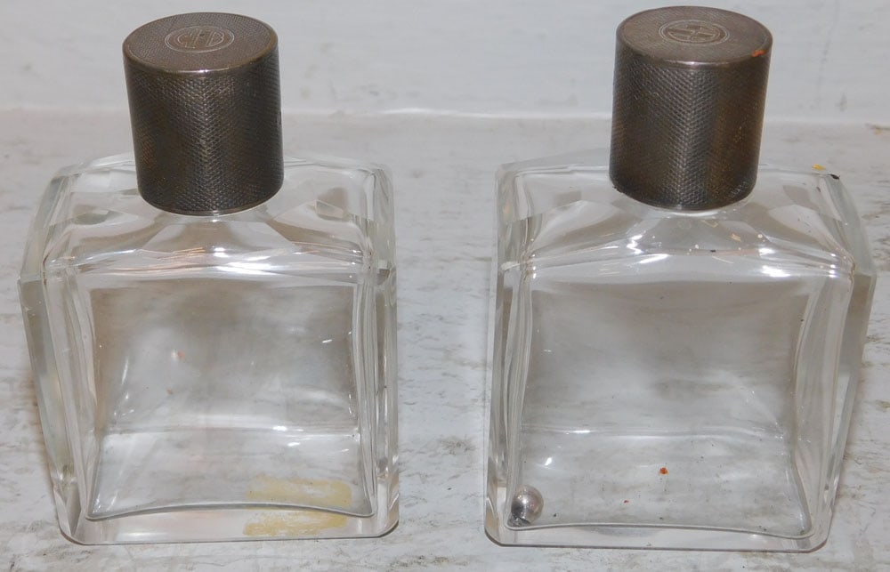 Two Sterling Top Perfume Bottles: Two Sterling Top Perfume Bottles. 3 3/4" H 2 1/2" W 1 1/2" D ALL DESCRIPTIONS AND ANY CONDITION STATEMENT GIVEN BY LANGSTON AUCTION GALLERY ARE STRICTLY OPINIONS AND LANGSTON'S SHALL HAVE NO