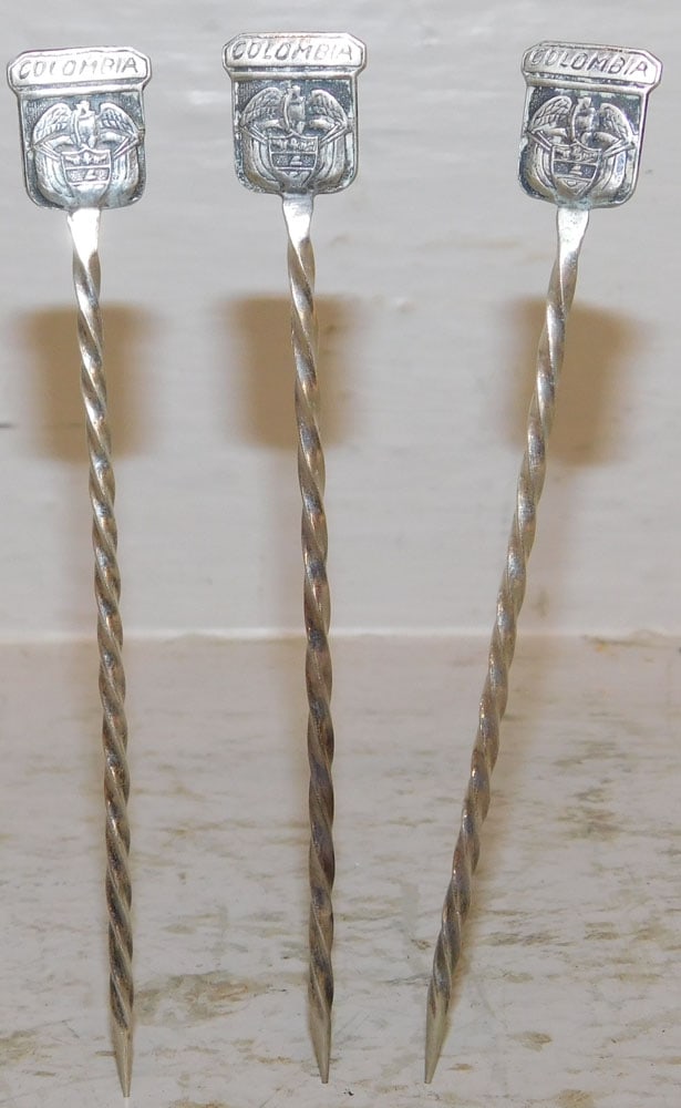 Three 800 Silver Colombia Cocktail Picks, .66 ozt.: Three 800 Silver Colombia Cocktail Picks, .66 ozt.. 4 1/2" L ALL DESCRIPTIONS AND ANY CONDITION STATEMENT GIVEN BY LANGSTON AUCTION GALLERY ARE STRICTLY OPINIONS AND LANGSTON'S SHALL HAVE NO