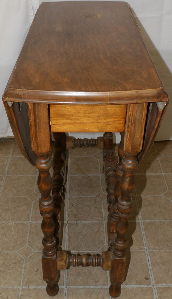 Antique Walnut Gate Leg Table: Antique Walnut Gate Leg Table. 30 1/2" H 30" W 13 1/2" D "ALL DESCRIPTIONS AND ANY CONDITION STATEMENT GIVEN BY LANGSTON AUCTION GALLERY ARE STRICTLY OPINIONS AND LANGSTON'S SHALL HAVE NO