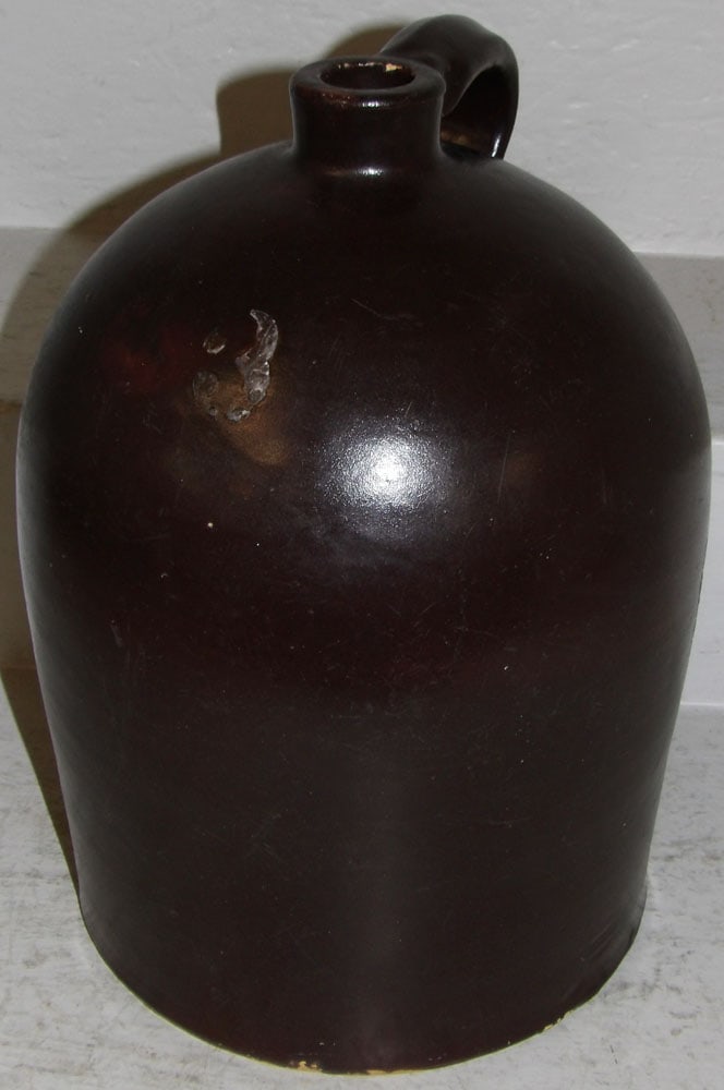Three Gallon Stoneware Chocolate Brown Whisky Jug with Handle: Three Gallon Stoneware Chocolate Brown Whisky Jug with Handle. 14 1/4" H 10 1/2" W "ALL DESCRIPTIONS AND ANY CONDITION STATEMENT GIVEN BY LANGSTON AUCTION GALLERY ARE STRICTLY OPINIONS AND LANGSTON'S