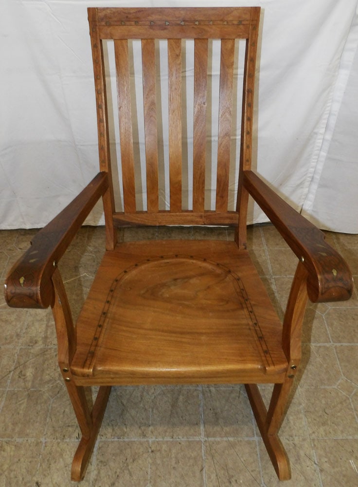 Teak Wood & Brass Inlaid Rocker: Teak Wood & Brass Inlaid Rocker . 36 1/4" H 24 1/2" W 33 1/2" D "ALL DESCRIPTIONS AND ANY CONDITION STATEMENT GIVEN BY LANGSTON AUCTION GALLERY ARE STRICTLY OPINIONS AND LANGSTON'S SHALL HAVE NO