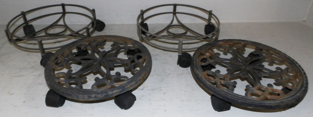 Two Metal & Two Cast Iron Rolling Planter Stands: Two Metal & Two Cast Iron Rolling Planter Stands . 2 3/4" H 12" Dia. "ALL DESCRIPTIONS AND ANY CONDITION STATEMENT GIVEN BY LANGSTON AUCTION GALLERY ARE STRICTLY OPINIONS AND LANGSTON'S SHALL HAVE NO