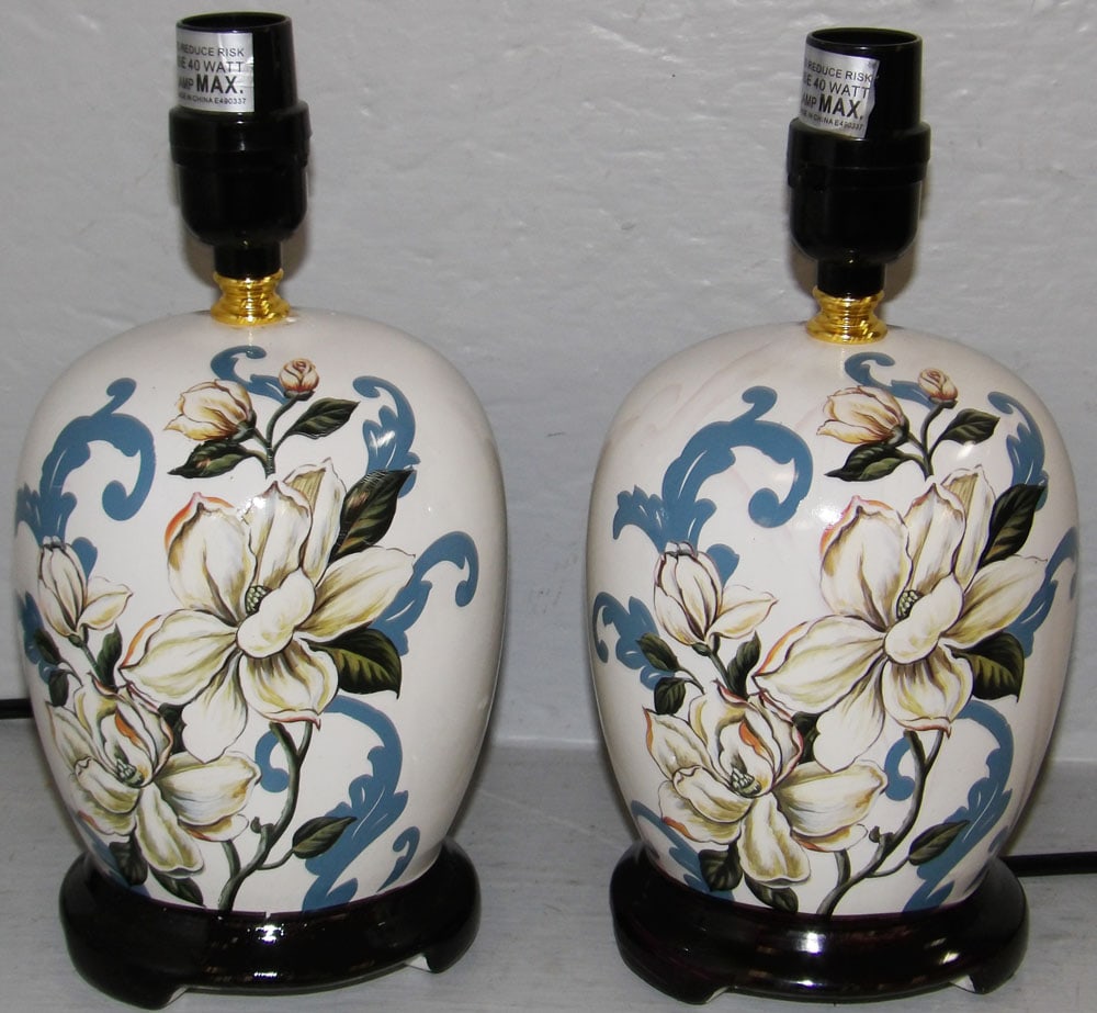 Pair of Paint Decorated Magnolia Motif Dresser Lamps: Pair of Paint Decorated Magnolia Motif Dresser Lamps. 10 3/4" x 5" Dia. "ALL DESCRIPTIONS AND ANY CONDITION STATEMENT GIVEN BY LANGSTON AUCTION GALLERY ARE STRICTLY OPINIONS AND LANGSTON'S SHALL HAVE