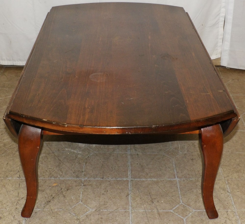 Cherry Drop Leaf Coffee Table: Cherry Drop Leaf Coffee Table . 14 1/2" H 42" W 23" D "ALL DESCRIPTIONS AND ANY CONDITION STATEMENT GIVEN BY LANGSTON AUCTION GALLERY ARE STRICTLY OPINIONS AND LANGSTON'S SHALL HAVE NO RESPONSIBILITY