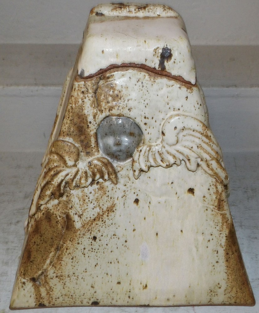 Signed Pottery Covered Urn with Cherub Face: Signed Pottery Covered Urn with Cherub Face. 13 1/2" H 13 1/4" W 13" D ALL DESCRIPTIONS AND ANY CONDITION STATEMENT GIVEN BY LANGSTON AUCTION GALLERY ARE STRICTLY OPINIONS AND LANGSTON'S SHALL HAVE NO