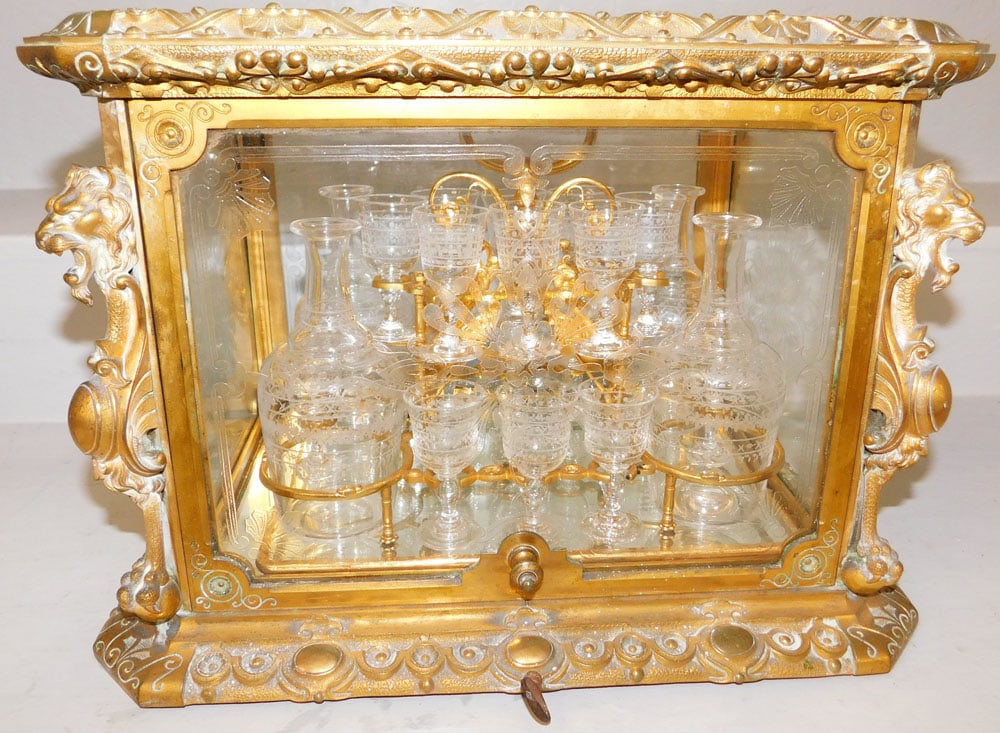 19th Century Ornate Gilded Metal Liqueur Cellar with Crystal Tantalus Marked "Tahan Fr del'Empereur": 19th Century Ornate Gilded Metal Liqueur Cellar with Crystal Tantalus Marked "Tahan Fr del'Empereur". 12" H 16 1/4" W 12 3/4" D ALL DESCRIPTIONS AND ANY CONDITION STATEMENT GIVEN BY LANGSTON AUCTION
