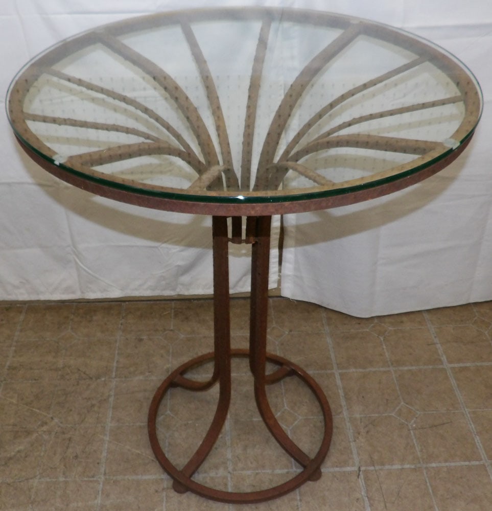 Wrought Iron & Glass Top Outdoor Table: Wrought Iron & Glass Top Outdoor Table. 36 1/4" H 30" Dia. "ALL DESCRIPTIONS AND ANY CONDITION STATEMENT GIVEN BY LANGSTON AUCTION GALLERY ARE STRICTLY OPINIONS AND LANGSTON'S SHALL HAVE NO