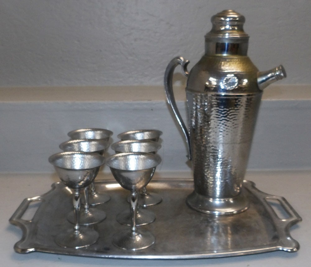 Stainless Steel Cocktail Shaker with Six Coupes & Tray: Stainless Steel Cocktail Shaker with Six Coupes & Tray. Up to 7 1/4" x 11 3/4" "ALL DESCRIPTIONS AND ANY CONDITION STATEMENT GIVEN BY LANGSTON AUCTION GALLERY ARE STRICTLY OPINIONS AND LANGSTON'S
