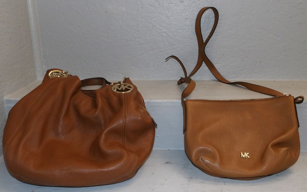 Two Michael Kors Ladies Bags: Two Michael Kors Ladies Bags. Up to 12" x 13" "ALL DESCRIPTIONS AND ANY CONDITION STATEMENT GIVEN BY LANGSTON AUCTION GALLERY ARE STRICTLY OPINIONS AND LANGSTON'S SHALL HAVE NO RESPONSIBILITY FOR