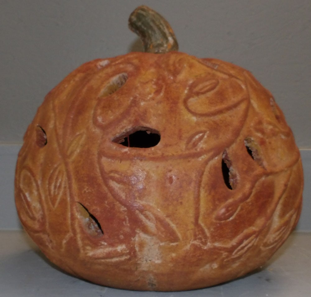 Pottery Pumpkin Form Lantern: Pottery Pumpkin Form Lantern. 13" H 13 1/2" Dia. "ALL DESCRIPTIONS AND ANY CONDITION STATEMENT GIVEN BY LANGSTON AUCTION GALLERY ARE STRICTLY OPINIONS AND LANGSTON'S SHALL HAVE NO RESPONSIBILITY FOR