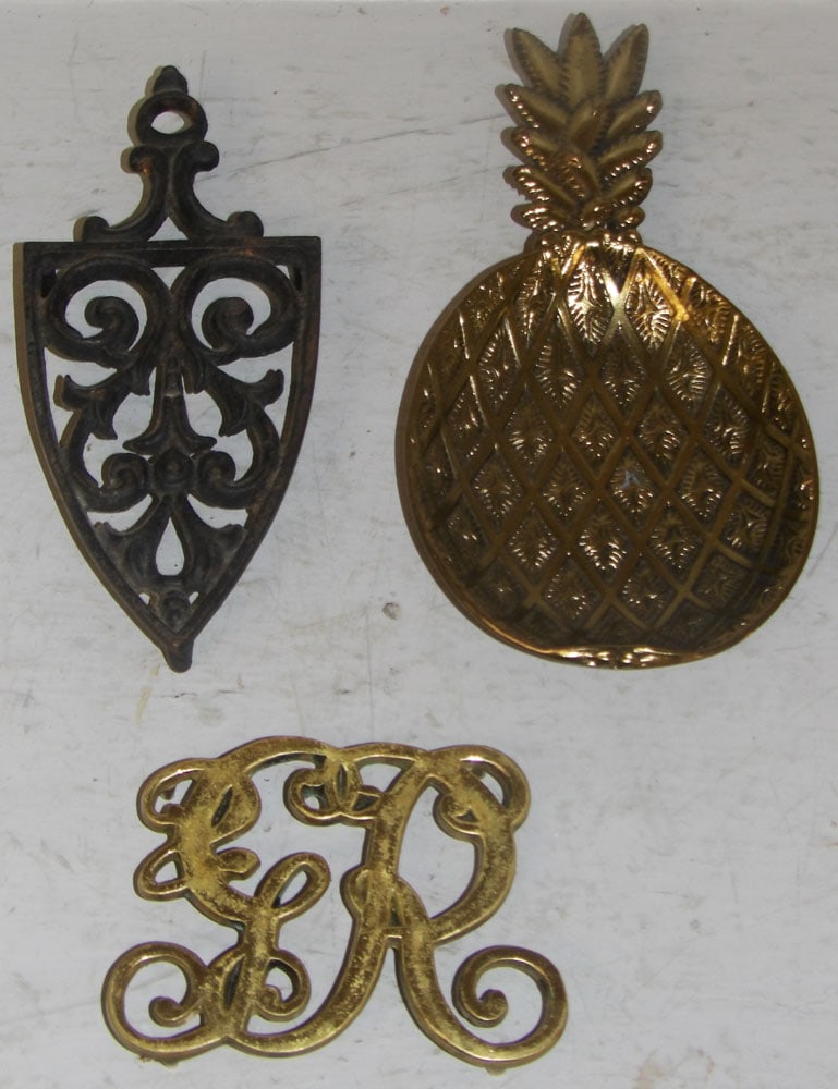 Brass & Cast Iron VA Metalcrafters Trivets & Gilded Metal Pineapple Form Dish: Brass & Cast Iron VA Metalcrafters Trivets & Gilded Metal Pineapple Form Dish. Up to 9 3/4" L 5" W ALL DESCRIPTIONS AND ANY CONDITION STATEMENT GIVEN BY LANGSTON AUCTION GALLERY ARE STRICTLY OPINIONS 