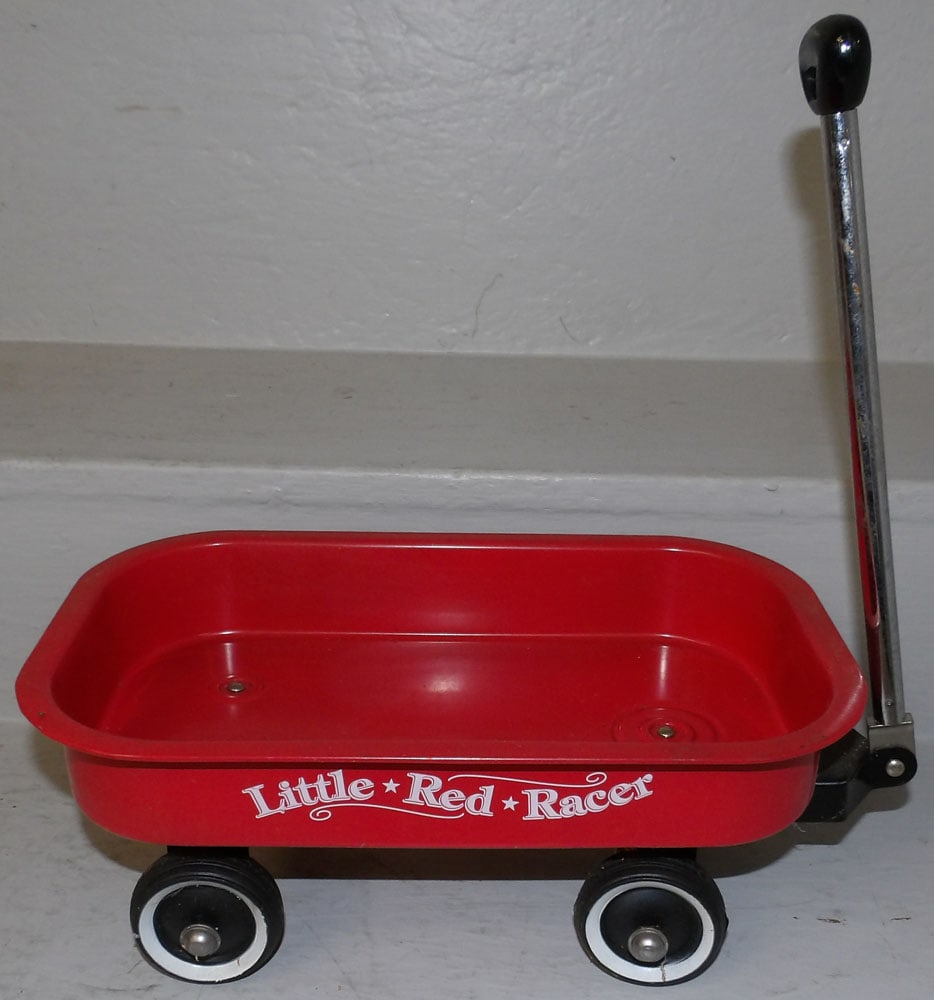Little Red Racer Metal Doll Wagon: Little Red Racer Metal Doll Wagon . 5" H 23" L ALL DESCRIPTIONS AND ANY CONDITION STATEMENT GIVEN BY LANGSTON AUCTION GALLERY ARE STRICTLY OPINIONS AND LANGSTON'S SHALL HAVE NO RESPONSIBILITY FOR