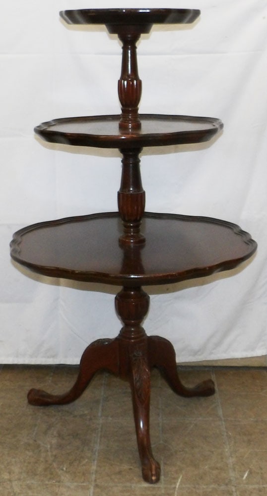 Mahogany Three Tier Dumbwaiter: Mahogany Three Tier Dumbwaiter. 39" H 23 1/2" Dia. ALL DESCRIPTIONS AND ANY CONDITION STATEMENT GIVEN BY LANGSTON AUCTION GALLERY ARE STRICTLY OPINIONS AND LANGSTON'S SHALL HAVE NO RESPONSIBILITY FOR