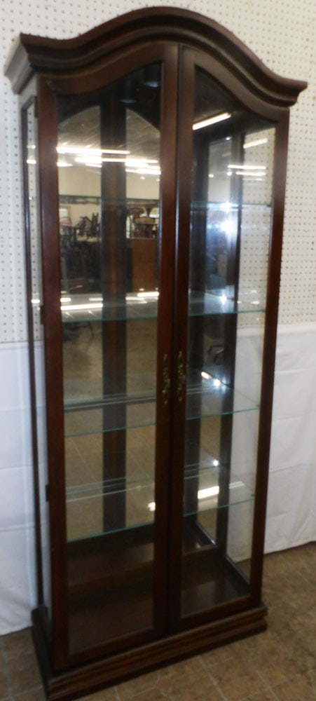 Cherry Two Door Lighted Curio Cabinet: Cherry Two Door Lighted Curio Cabinet . 80 1/4" H 33 1/4" W 12 1/2" D ALL DESCRIPTIONS AND ANY CONDITION STATEMENT GIVEN BY LANGSTON AUCTION GALLERY ARE STRICTLY OPINIONS AND LANGSTON'S SHALL HAVE NO