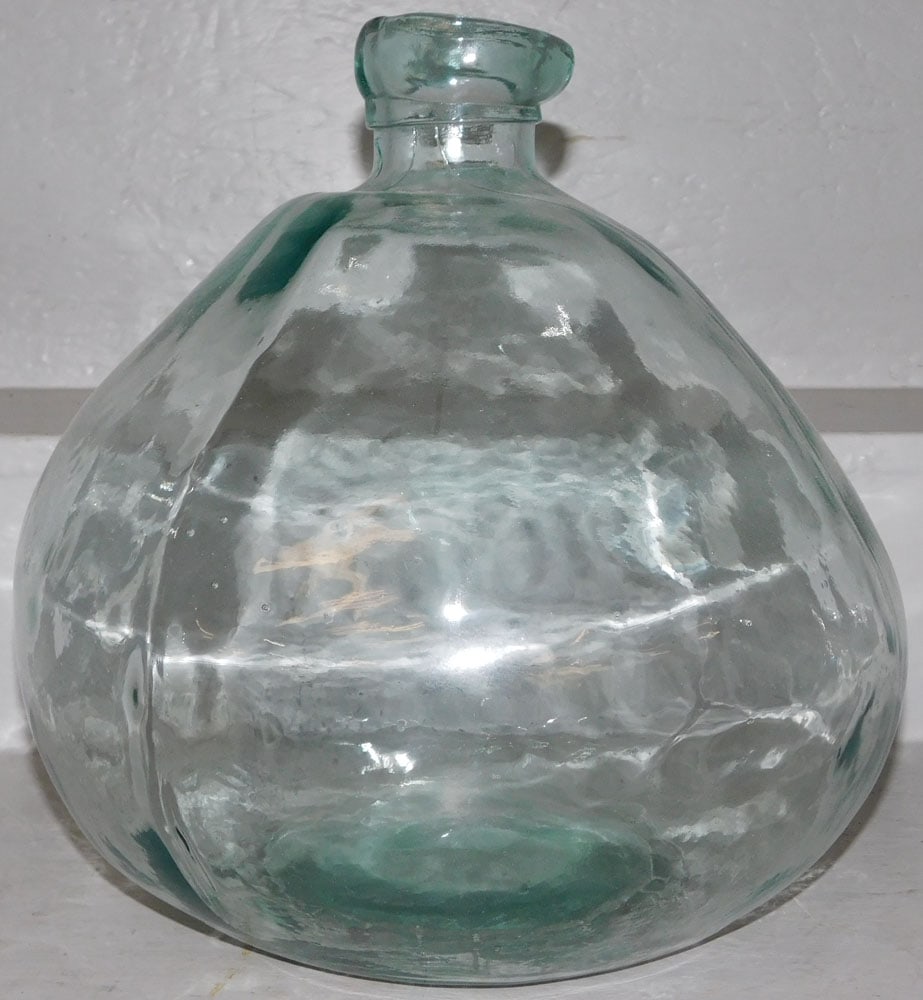 Decorative Glass Bottle Form Vase: Decorative Glass Bottle Form Vase. 12" H 12 1/2" Dia. ALL DESCRIPTIONS AND ANY CONDITION STATEMENT GIVEN BY LANGSTON AUCTION GALLERY ARE STRICTLY OPINIONS AND LANGSTON'S SHALL HAVE NO RESPONSIBILITY F
