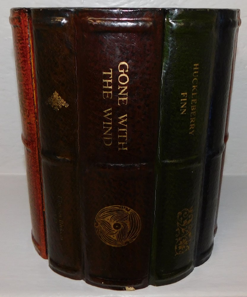 Painted Faux Book Waste Basket: Painted Faux Book Waste Basket . 9 1/2" H 8 1/2" Dia. "ALL DESCRIPTIONS AND ANY CONDITION STATEMENT GIVEN BY LANGSTON AUCTION GALLERY ARE STRICTLY OPINIONS AND LANGSTON'S SHALL HAVE NO RESPONSIBILITY