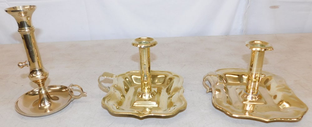 Three Brass Candlesticks: Three Brass Candlesticks . Up to 7 3/4" H 5 3/4" W "ALL DESCRIPTIONS AND ANY CONDITION STATEMENT GIVEN BY LANGSTON AUCTION GALLERY ARE STRICTLY OPINIONS AND LANGSTON'S SHALL HAVE NO RESPONSIBILITY