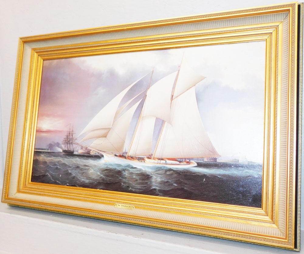Framed Print on Canvas Titled "Yachts Magic Defending America's Cup" by James E Buttersworth: Framed Print on Canvas Titled "Yachts Magic Defending America's Cup" by James E Buttersworth . 26 3/4" x 40 1/2" "ALL DESCRIPTIONS AND ANY CONDITION STATEMENT GIVEN BY LANGSTON AUCTION GALLERY ARE