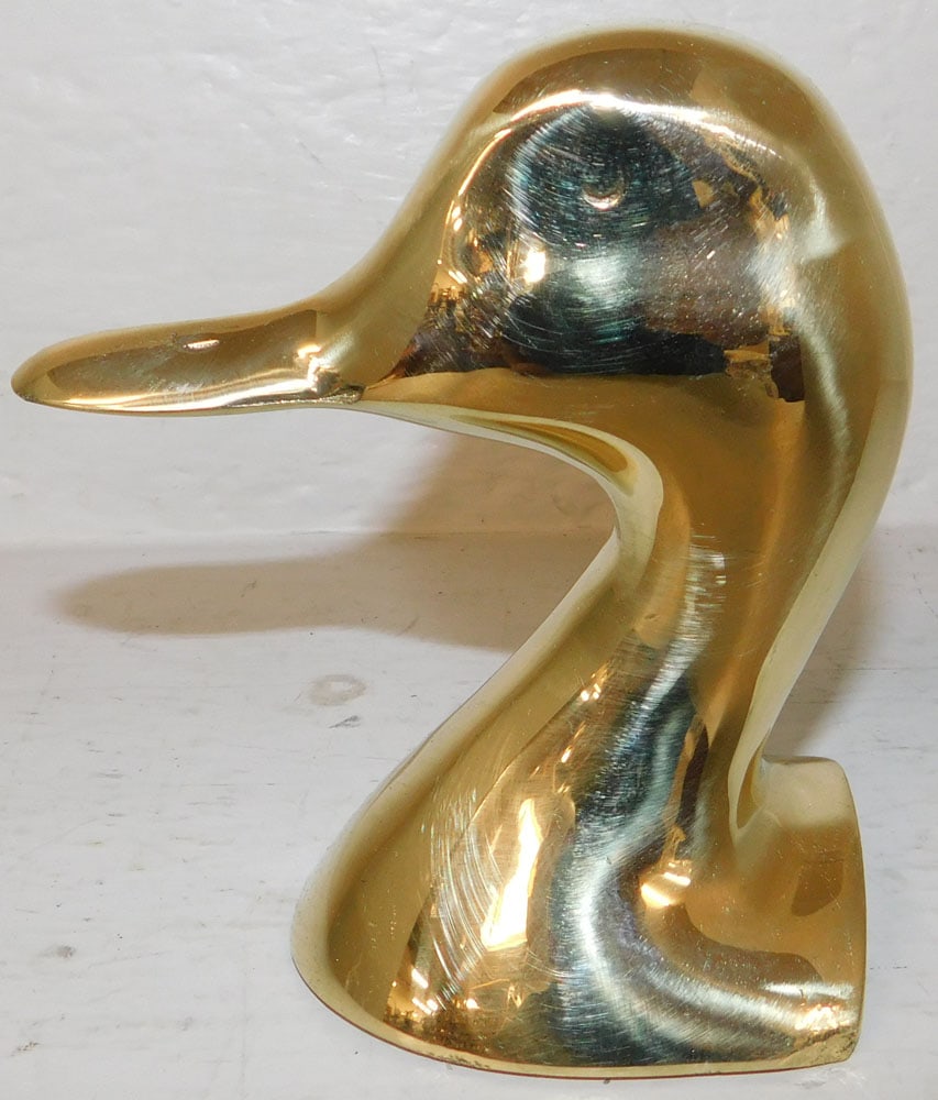 Polished Brass Duck Head Door Stop by VA Metalcrafters: Polished Brass Duck Head Door Stop by VA Metalcrafters . 5 1/4" H 5 1/4" W "ALL DESCRIPTIONS AND ANY CONDITION STATEMENT GIVEN BY LANGSTON AUCTION GALLERY ARE STRICTLY OPINIONS AND LANGSTON'S SHALL