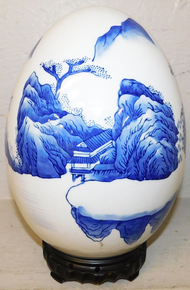 Oriental Blue & White Porcelain Egg on Teak Wood Stand: Oriental Blue & White Porcelain Egg on Teak Wood Stand . 11 1/2" H 7 1/2" Dia. "ALL DESCRIPTIONS AND ANY CONDITION STATEMENT GIVEN BY LANGSTON AUCTION GALLERY ARE STRICTLY OPINIONS AND LANGSTON'S