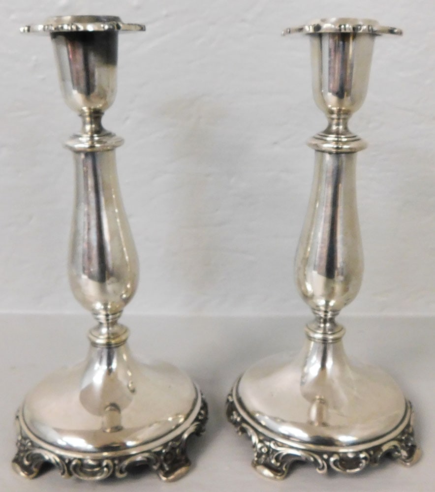 Pair of Silverplated Candlesticks by Roger Bros.: Pair of Silverplated Candlesticks by Roger Bros.. 9" H 5" Dia. "ALL DESCRIPTIONS AND ANY CONDITION STATEMENT GIVEN BY LANGSTON AUCTION GALLERY ARE STRICTLY OPINIONS AND LANGSTON'S SHALL HAVE NO