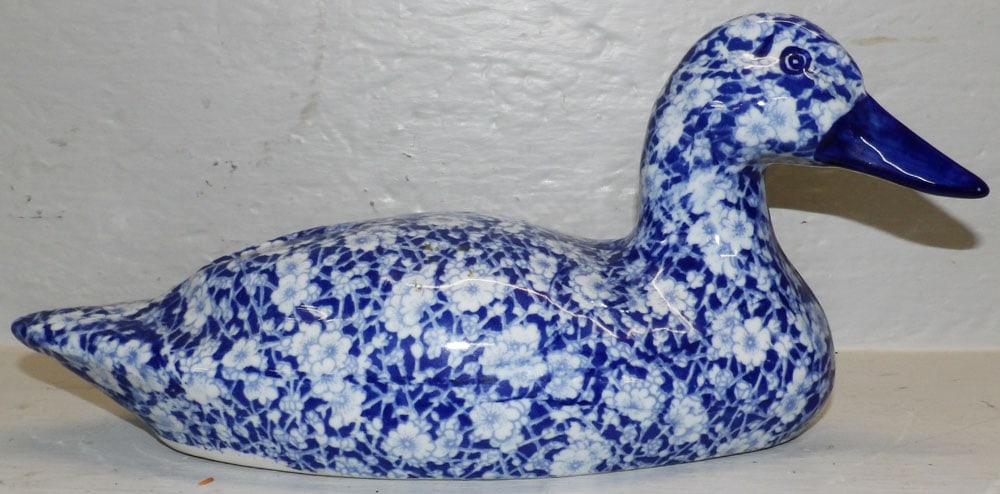 Blue & White Floral Motif Porcelain Duck Decoy: Blue & White Floral Motif Porcelain Duck Decoy. 6 1/4" H 14" L "ALL DESCRIPTIONS AND ANY CONDITION STATEMENT GIVEN BY LANGSTON AUCTION GALLERY ARE STRICTLY OPINIONS AND LANGSTON'S SHALL HAVE NO
