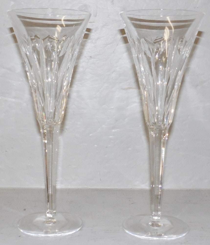 Two Waterford Champagne Flutes: Two Waterford Champagne Flutes . 9 1/4" H 3 1/2" Dia. "ALL DESCRIPTIONS AND ANY CONDITION STATEMENT GIVEN BY LANGSTON AUCTION GALLERY ARE STRICTLY OPINIONS AND LANGSTON'S SHALL HAVE NO RESPONSIBILITY