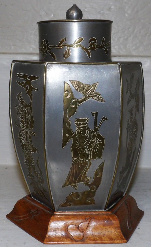 Oriental Pewter Brass & Inlaid Tea Cannister with Teak Wood Stand: Oriental Pewter Brass & Inlaid Tea Cannister with Teak Wood Stand . 7 3/4" H 4 1/2" Dia. "ALL DESCRIPTIONS AND ANY CONDITION STATEMENT GIVEN BY LANGSTON AUCTION GALLERY ARE STRICTLY OPINIONS AND LANGS