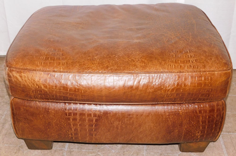 Leather Upholstered Ottoman: Leather Upholstered Ottoman . 15 1/2" H 30 1/2" W 23 1/2" D "ALL DESCRIPTIONS AND ANY CONDITION STATEMENT GIVEN BY LANGSTON AUCTION GALLERY ARE STRICTLY OPINIONS AND LANGSTON'S SHALL HAVE NO RESPONSIB