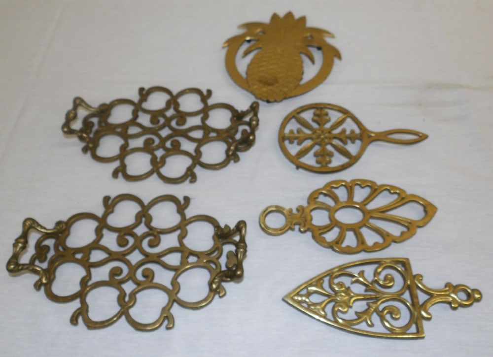 Lot of Brass Trivets: Lot of Brass Trivets . Up to 9 1/2" W 6 1/4" D "ALL DESCRIPTIONS AND ANY CONDITION STATEMENT GIVEN BY LANGSTON AUCTION GALLERY ARE STRICTLY OPINIONS AND LANGSTON'S SHALL HAVE NO RESPONSIBILITY FOR
