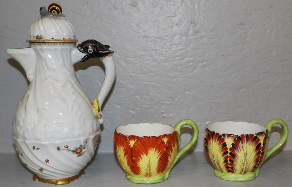 Painted Porcelain Tea Pot with Dolphin Handle by Mottahedeh & Two Cups: Painted Porcelain Tea Pot with Dolphin Handle by Mottahedeh & Two Cups. Up to 18 1/4" H 6 1/2" W "ALL DESCRIPTIONS AND ANY CONDITION STATEMENT GIVEN BY LANGSTON AUCTION GALLERY ARE STRICTLY OPINIONS