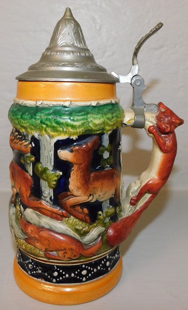 Porcelain German Stein with Hunting Scene Motif: Porcelain German Stein with Hunting Scene Motif. 7 1/4" H 4 1/2" W "ALL DESCRIPTIONS AND ANY CONDITION STATEMENT GIVEN BY LANGSTON AUCTION GALLERY ARE STRICTLY OPINIONS AND LANGSTON'S SHALL HAVE NO