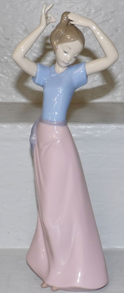 NAO by Lladro Figurine: NAO by Lladro Figurine . 11" H 4" W "ALL DESCRIPTIONS AND ANY CONDITION STATEMENT GIVEN BY LANGSTON AUCTION GALLERY ARE STRICTLY OPINIONS AND LANGSTON'S SHALL HAVE NO RESPONSIBILITY FOR ERRORS OR