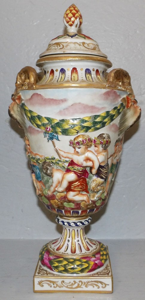 Painted Porcelain Capodimonte Covered Urn, (Chip on Lid): Painted Porcelain Capodimonte Covered Urn, (Chip on Lid). 15 1/2" H 7 1/2" W "ALL DESCRIPTIONS AND ANY CONDITION STATEMENT GIVEN BY LANGSTON AUCTION GALLERY ARE STRICTLY OPINIONS AND LANGSTON'S SHALL