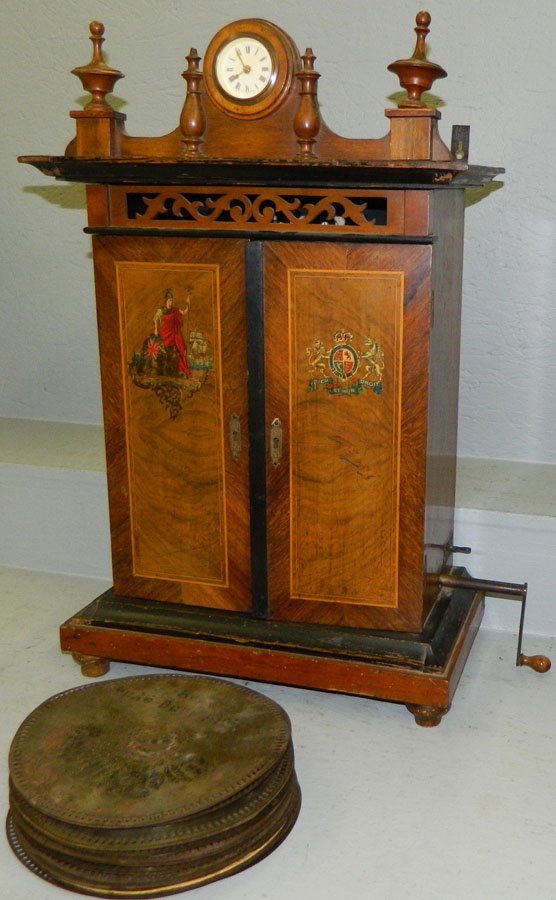 St. Croix Silver Star Depot London music box.: St. Croix Silver Star Depot London music box with double cylinder and pocket watch in molding. Includes 22 discs, measuring 9" diameter. 16 1/2" wide x 9 1/2" deep x 26" tall.