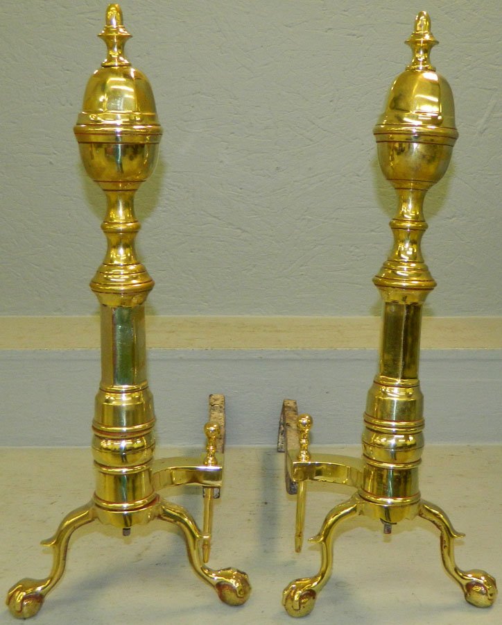 Pair of claw foot brass andirons.: Pair of claw foot brass andirons. 23" tall.