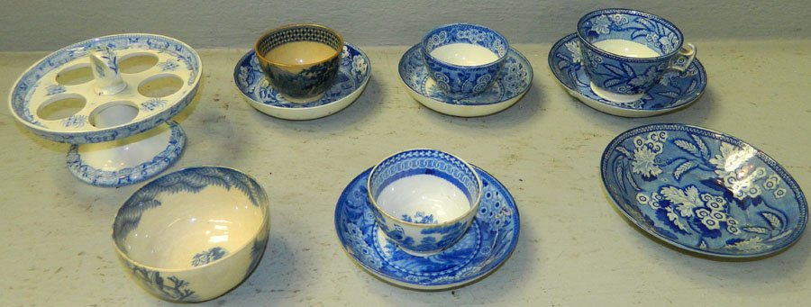 Early blue decorated items.: (4) Early blue decorated saucers with cans, (1) blue decorated cup with saucer, and (1) blue decorated egg plate.