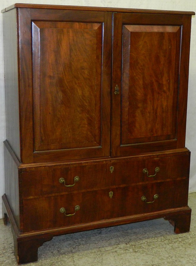 Mahogany two drawer linen press.: Late 18th Century - early 19th Century mahogany two drawer linen press with four pull out trays. 46" wide x 25" deep x 60" tall.