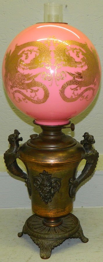 Gone with the wind lamp with metal base.: Gone with the wind lamp with metal base decorated with gargoyles. 29" tall.