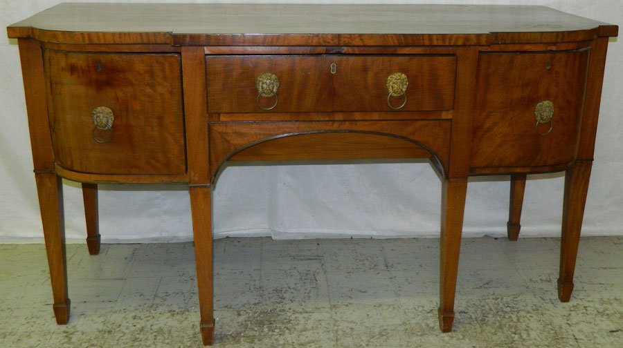 Mahogany Hepplewhite antique sideboard.: Mahogany Hepplewhite antique sideboard with bowed corners, cellarette drawer on right and cabinet door on left, Circa 1800. 66 1/4" wide x 28" deep x 36" tall.