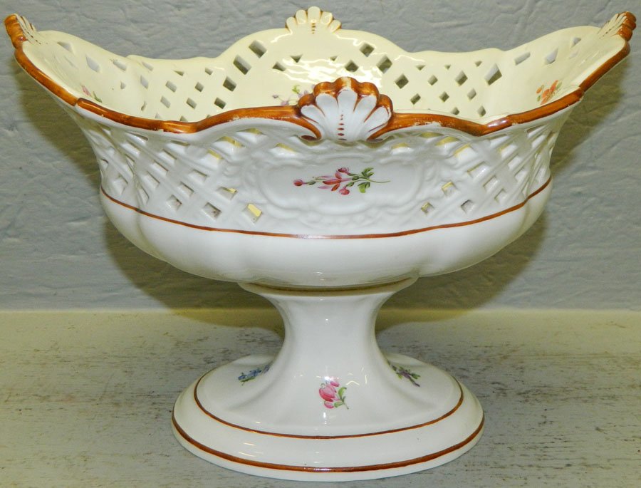 Meissen reticulated compote on stand.: Meissen reticulated compote on stand, with cross swords. Has hairline in the bottom. 7 1/4" tall.