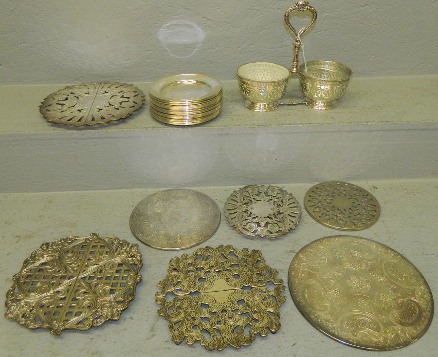 Box of silver plate.: Box of silver plate. Includes a cruet, (18) bread and butter plates, and (7) trivets.