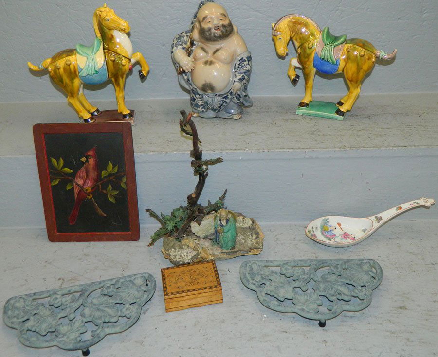 Box of Oriental pieces.: Box of Oriental pieces. Includes (2) horses, Buddha, mud figure, rice spoon, small box, and a trivet.